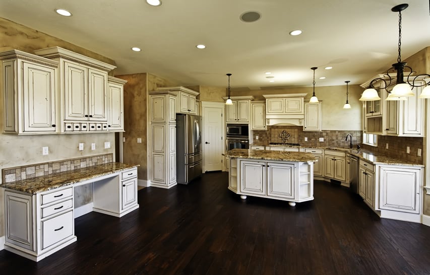 Massive white kitchen with distressed wood and granite island