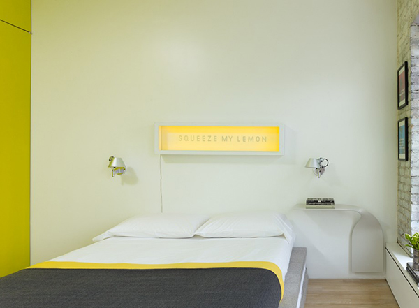 Yellow Green and white combination on limited space with modern bed lamps and customised bedside table.