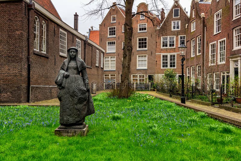 AMSTERDAM, NETHERLANDS - APRIL 9, 2018: Begijnhof is one of the oldest inner courts in the city of Amsterdam. A group of historic. Buildings, mostly private stock photos
