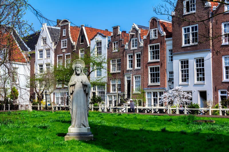 AMSTERDAM, NETHERLANDS - APRIL 11, 2018: Begijnhof is one of the oldest inner courts in the city of Amsterdam. A group of historic. Buildings, mostly private stock photos