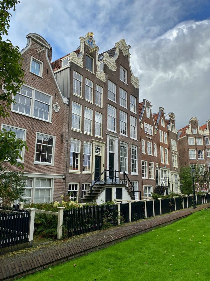 The Begijnhof is one of the oldest hofjes in Amsterdam. Amsterdam, Netherlands - October 3,2019:  The Begijnhof is one of the oldest hofjes in Amsterdam. A group stock images