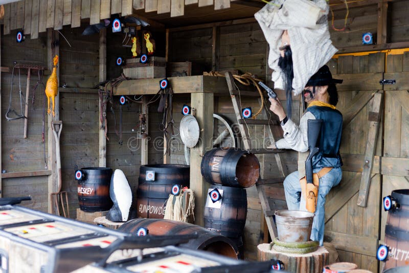 Amusement Park Arcade Target Shooting for Fun. Cowboy Themed Items are Marked with Bulls Eye Tag. Human Dummy Dressed as stock photos