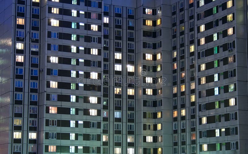 Apartment house evening. Russian modern contemporary architecture: illuminated widows in residental building / apartment house / dwelling house domestic building royalty free stock photo