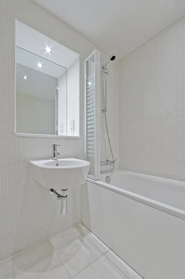 Bathroom with beige mosaic tiles. Luxury bathroom with beige mosaic tiles and modern appliances royalty free stock image