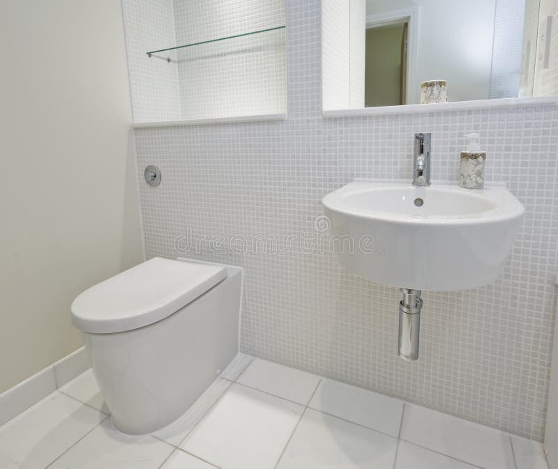 Bathroom with mosaic tiles. Contemporary bathroom with mosaic tiles and white ceramic appliances stock photos
