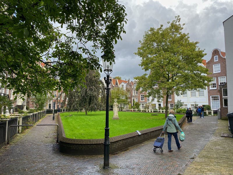 The Begijnhof is one of the oldest hofjes in Amsterdam. Amsterdam, Netherlands - October 3,2019:  The Begijnhof is one of the oldest hofjes in Amsterdam. A group stock photo