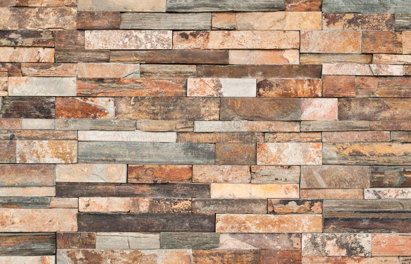 Brown stone wall tiles texture. Wall pattern design or abstract background stock photo