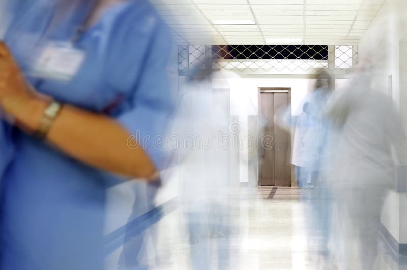 Busy hospital corridor. Blurred figures of doctors and nurses in a hospital corridor stock photography