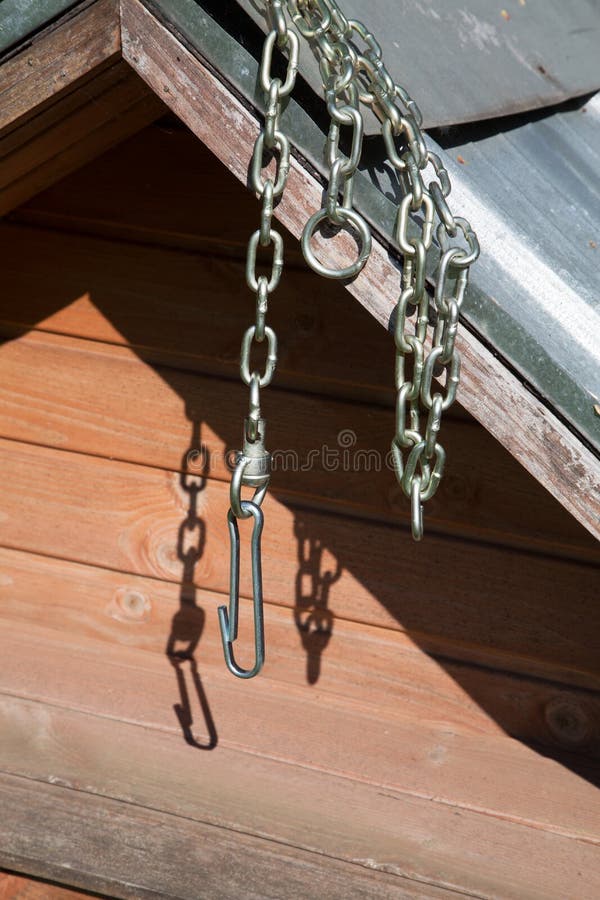 Chain for a dog hanging on a booth. On a sunny day royalty free stock photography