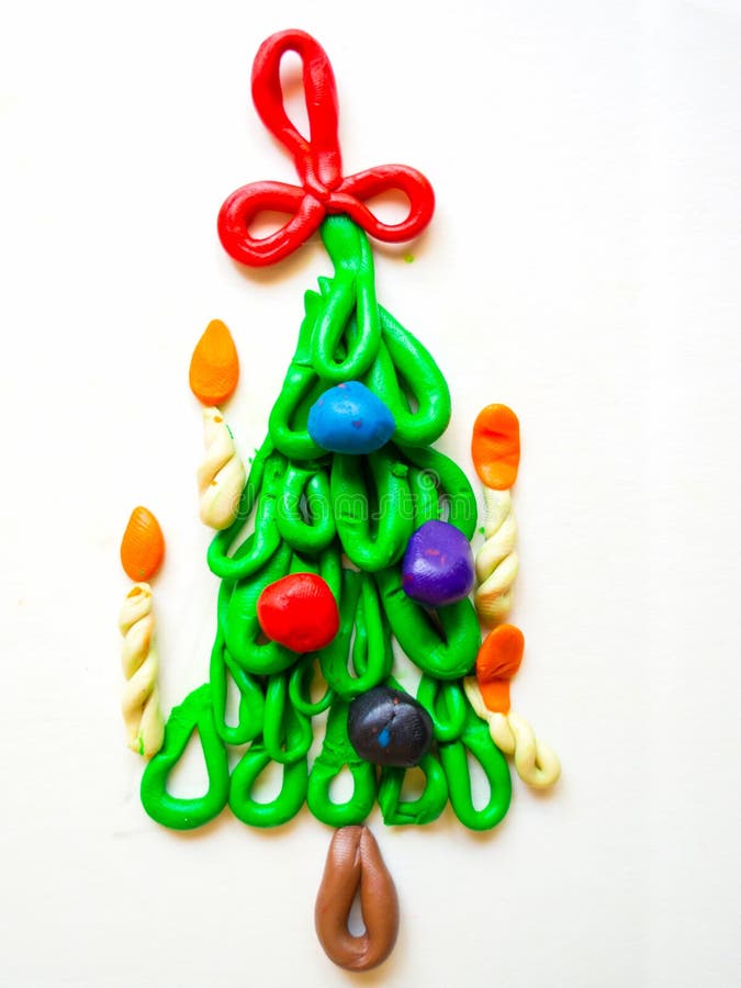 Children`s crafts Christmas tree with candles and balls of plasticine stock images