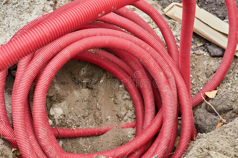 Close up of corrugated red drain pipe lays on the ground. Close up of corrugated red drain pipe lays on the ground stock photography