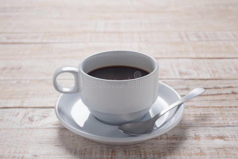 Cup of coffee on white wooden table background stock photography