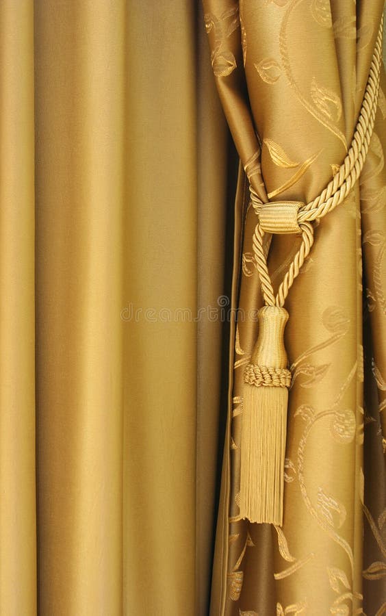 Curtains. Golden shining silky curtains with floral design stock photo