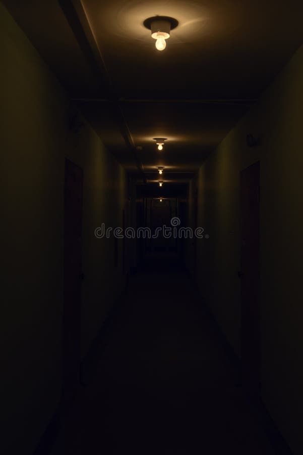 Dark corridor with glowing lamps stock image