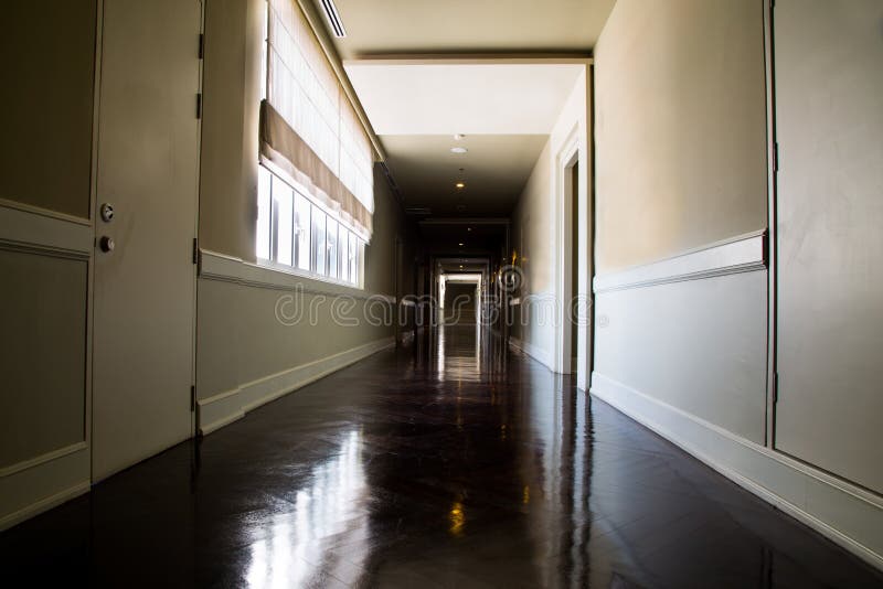 Dark and empty corridor with available natural light from window stock images