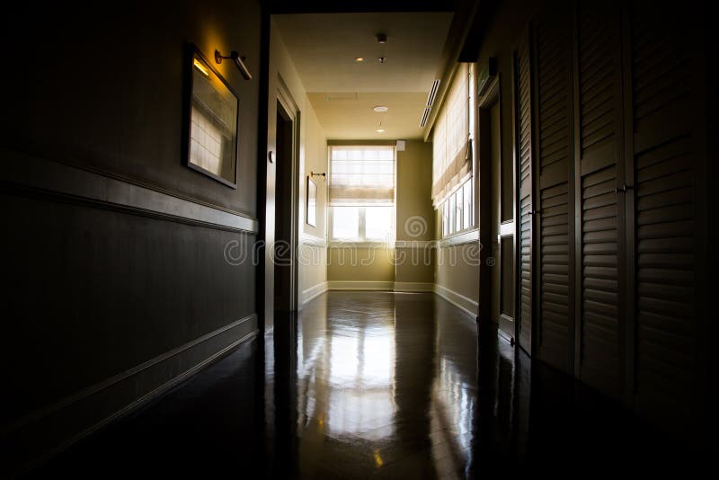 Dark and empty corridor with available natural light from window stock photos