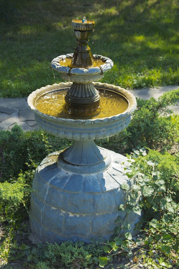 Decorative fountain in the courtyard of a private house. Decorative fountain in the courtyard royalty free stock photos