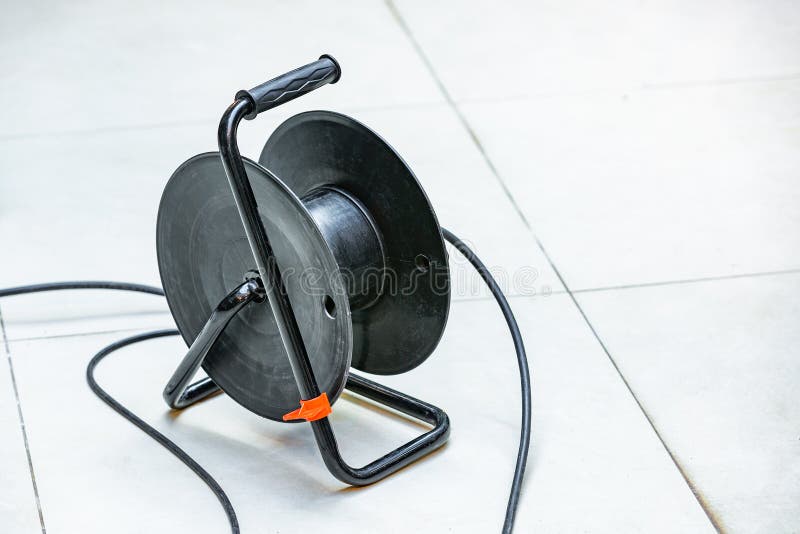 Power cord extension. The plug is inserted into the socket. Electrical cable extension reel. Rolled up sheathed electric cable for home or office to supply royalty free stock photos