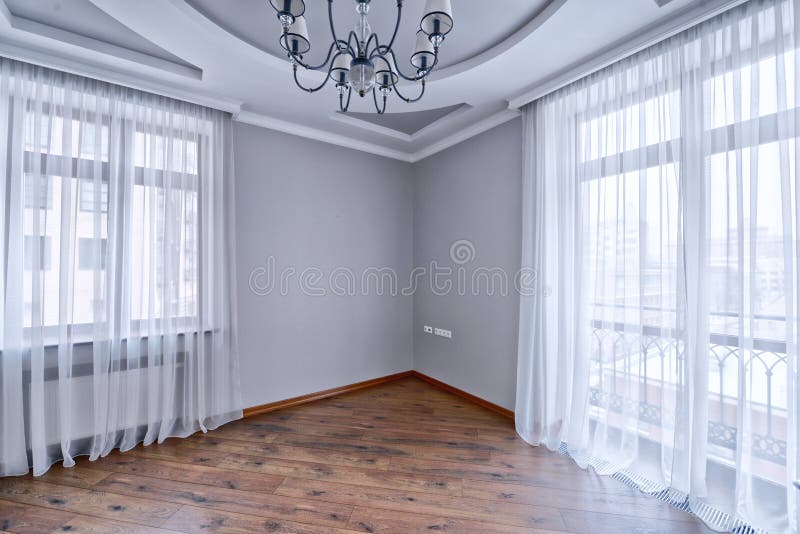 Elegant interior design with luxurious curtains and tulle. Russia,Moscow region - the elegant decor of the window curtains and tulle in a luxury country house stock image