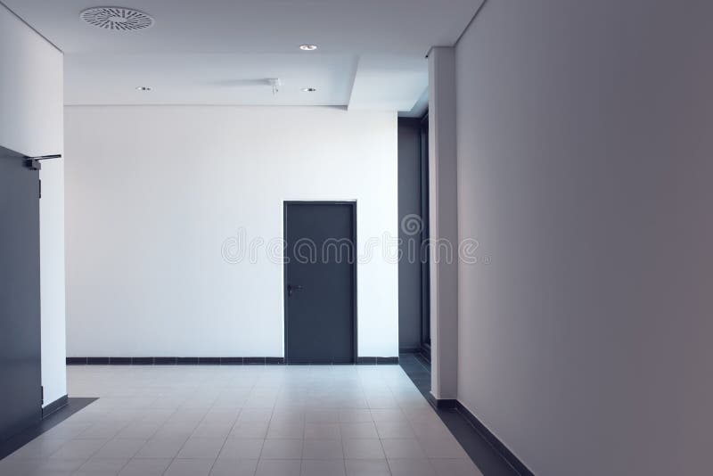 Empty corridor in modern business office building. Empty corridor in the modern business office building with blank white wall as copy space stock photos