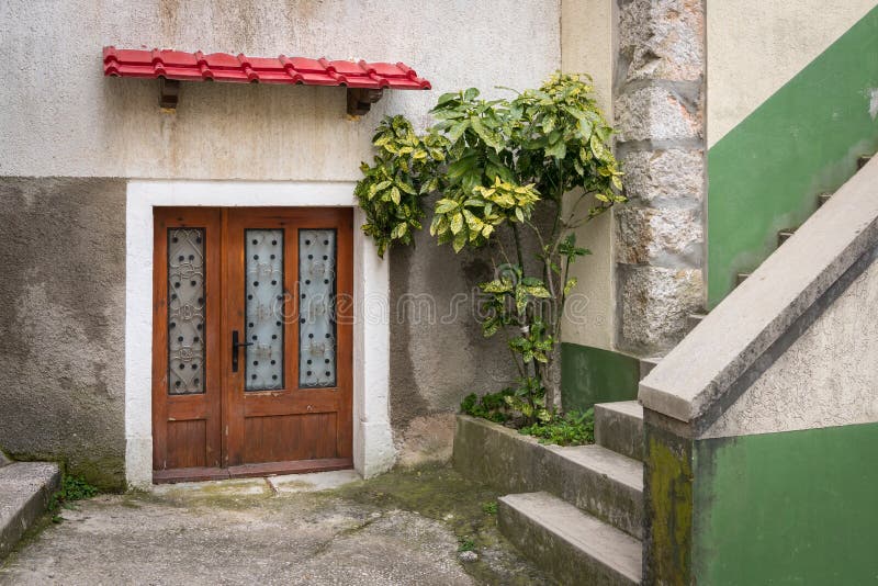 Entrance of a house in Beli, red canopy on a cloudy day in spring stock photography
