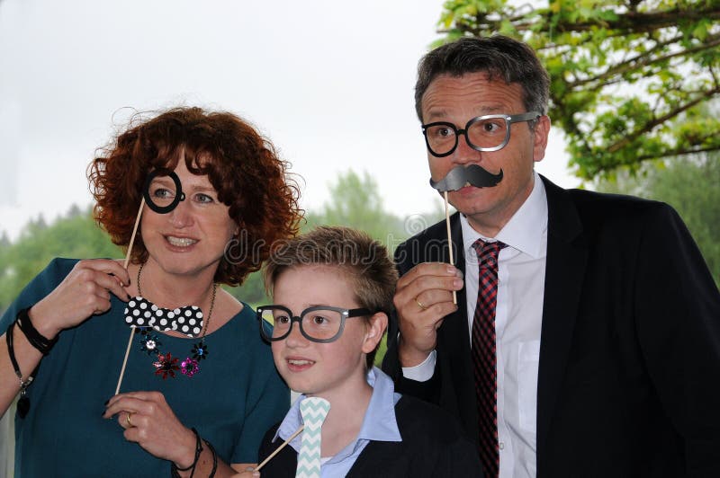 Family posing in front of a photo booth stock photography