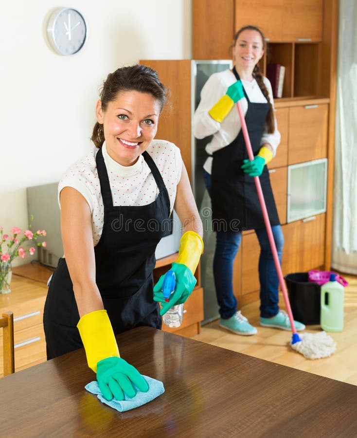 Female cleaners cleaning room royalty free stock photos
