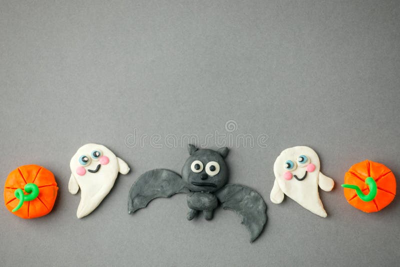 Funny toy pumpkins, ghost, bat from plasticine molded children. Scary Halloween background with open space for text. Banner. Creative DIY idea for kids royalty free stock photo