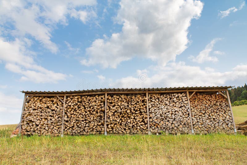 German shelter with lots of firewood in field stock image
