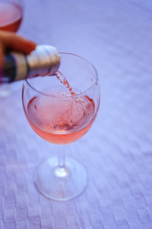 Enjoying a glass of rose wine on the veranda, summer holiday in Italy. Glass of rose wine outdoors on the balcony. Evening scenery, Italy enjoy vacation holiday royalty free stock image