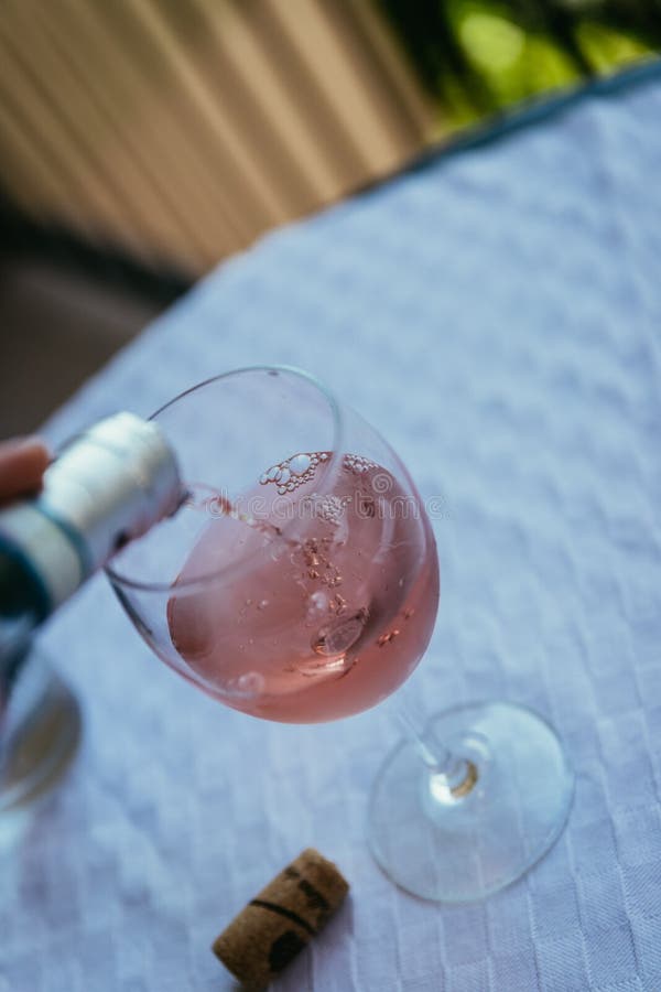 Enjoying a glass of rose wine on the veranda, summer holiday in Italy. Glass of rose wine outdoors on the balcony. Evening scenery, Italy enjoy vacation holiday stock photography