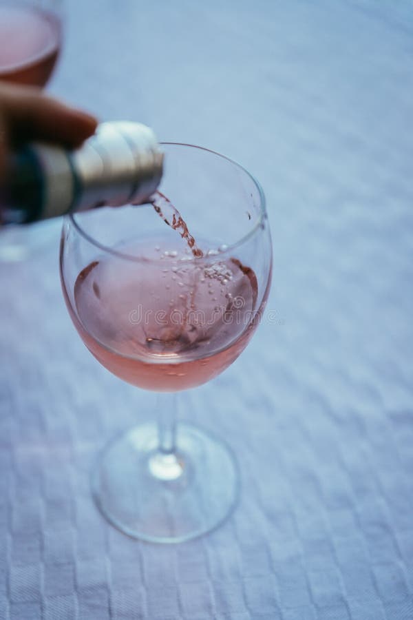 Enjoying a glass of rose wine on the veranda, summer holiday in Italy. Glass of rose wine outdoors on the balcony. Evening scenery, Italy enjoy vacation holiday royalty free stock photo