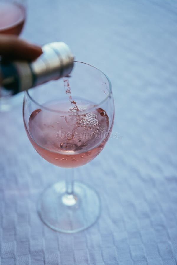 Enjoying a glass of rose wine on the veranda, summer holiday in Italy. Glass of rose wine outdoors on the balcony. Evening scenery, Italy enjoy vacation holiday stock images