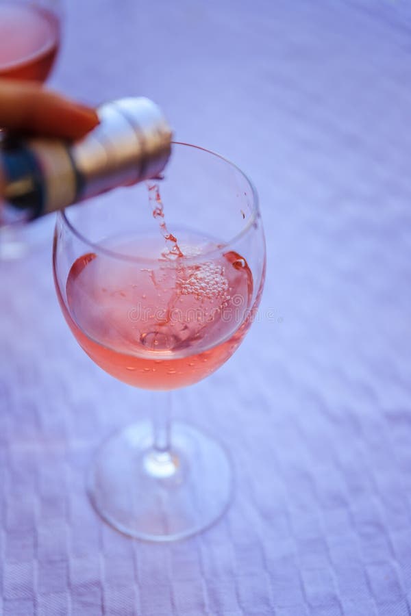 Enjoying a glass of rose wine on the veranda, summer holiday in Italy. Glass of rose wine outdoors on the balcony. Evening scenery, Italy enjoy vacation holiday stock photo