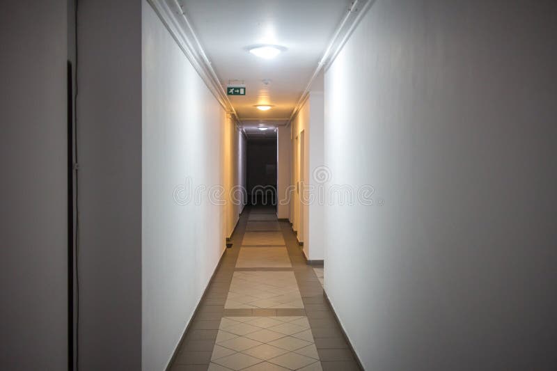 Hotel or apartment block corridor. Hotel or apartment block dark corridor with many doors royalty free stock image
