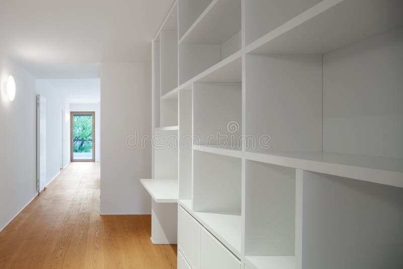 Interior of modern apartment, corridor. Interior of modern apartment with wooden floor, large open closet and windows. Detail corridor royalty free stock image
