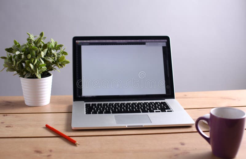 Laptop stands on a wooden table royalty free stock images