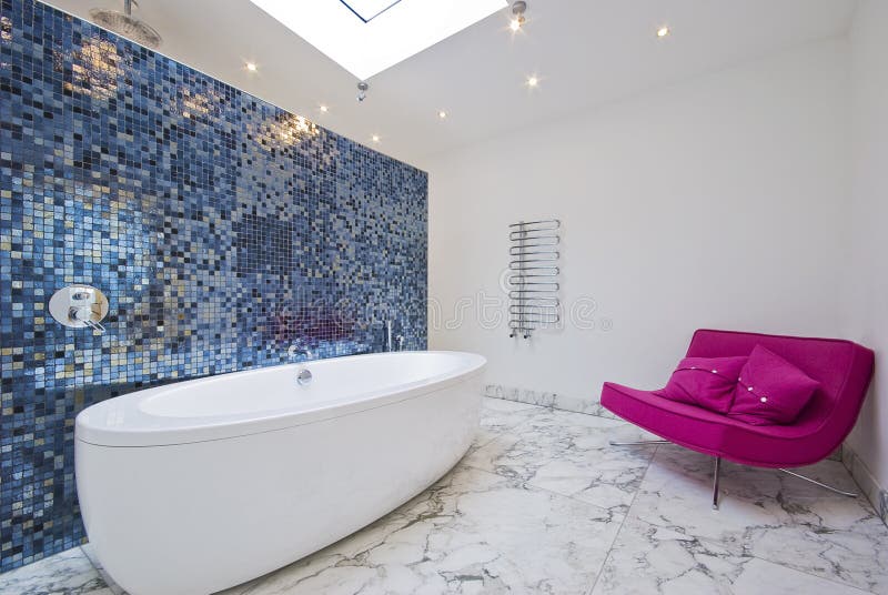 Luxury bathroom with sofa. Modern luxury bathroom with pink sofa mosaic tiles and marble floor stock photo