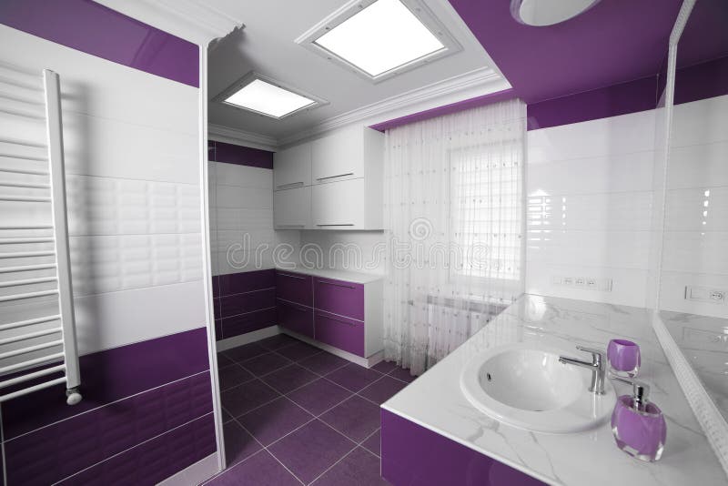 Modern Bathroom interior with a mosaic panel. White bathtub against violet and white wall royalty free stock photos