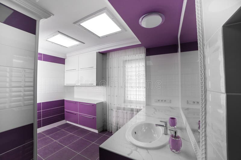 Modern Bathroom interior with a mosaic panel. White bathtub against violet and white wall stock photography