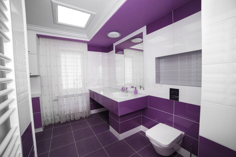 Modern Bathroom interior with a mosaic panel. White bathtub against violet and white wall royalty free stock photography