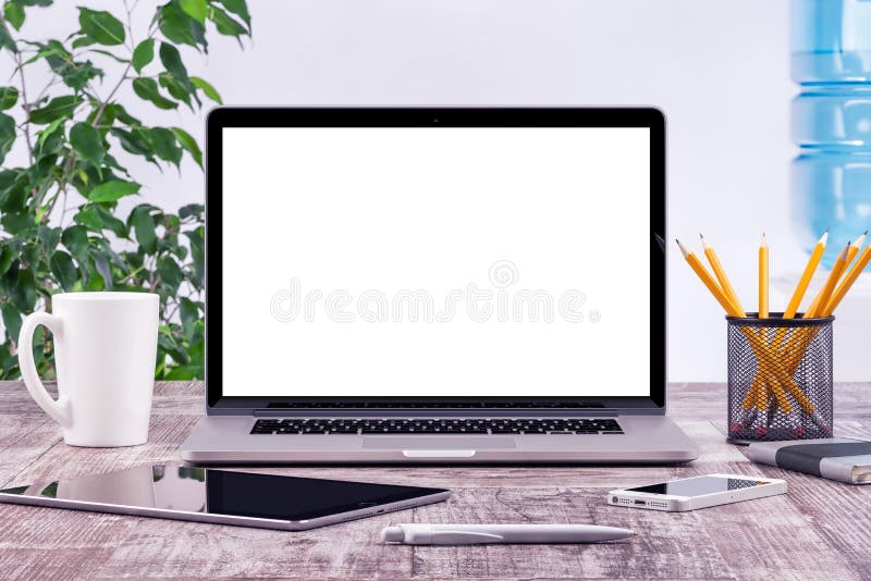 Office workplace with open laptop mockup tablet computer stock photo