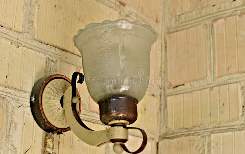 An old lantern illuminates the veranda of the house. royalty free stock photo