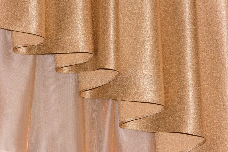 Open lambrequin (portiere, curtain) golden color. On the window. Classic interior decoration indoor openings lambrequins back into fashion stock photography