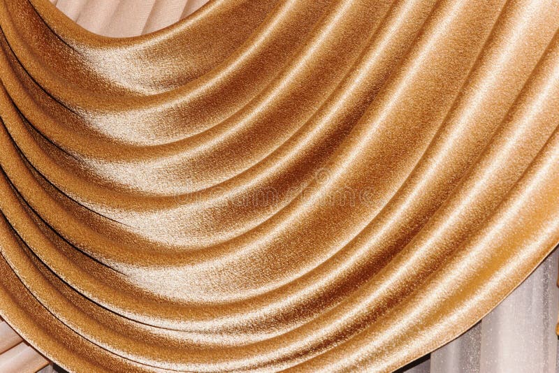 Open lambrequin (portiere, curtain) golden color. On the window. Classic interior decoration indoor openings lambrequins back into fashion stock image