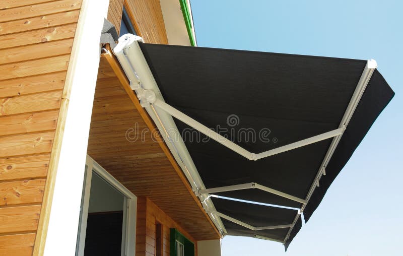 Outdoor high quality automatic sliding canopy retractable roof system, patio awning for sunshade of a modern wooden house stock photo