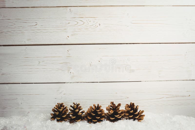 Pine cone decoration on fake snow royalty free stock image