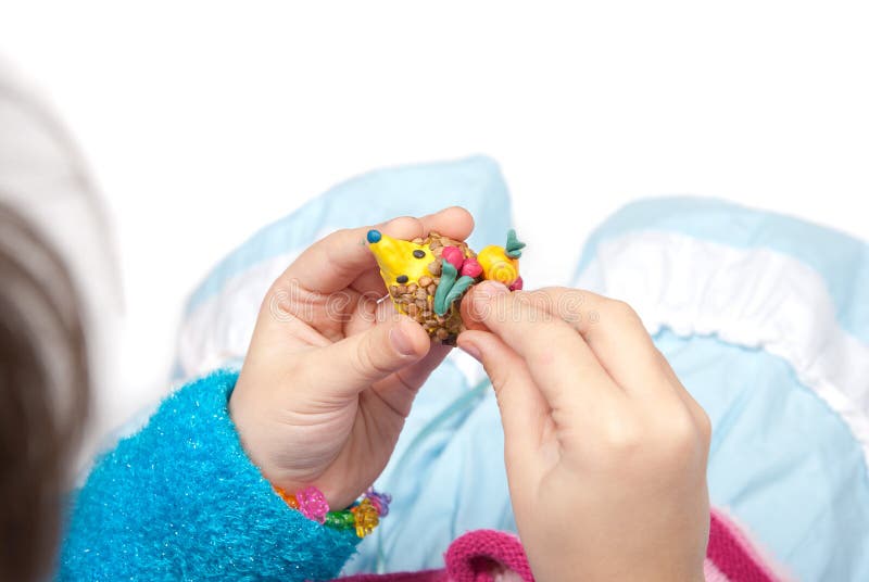 Plasticine. Hedgehog in the hands royalty free stock photo