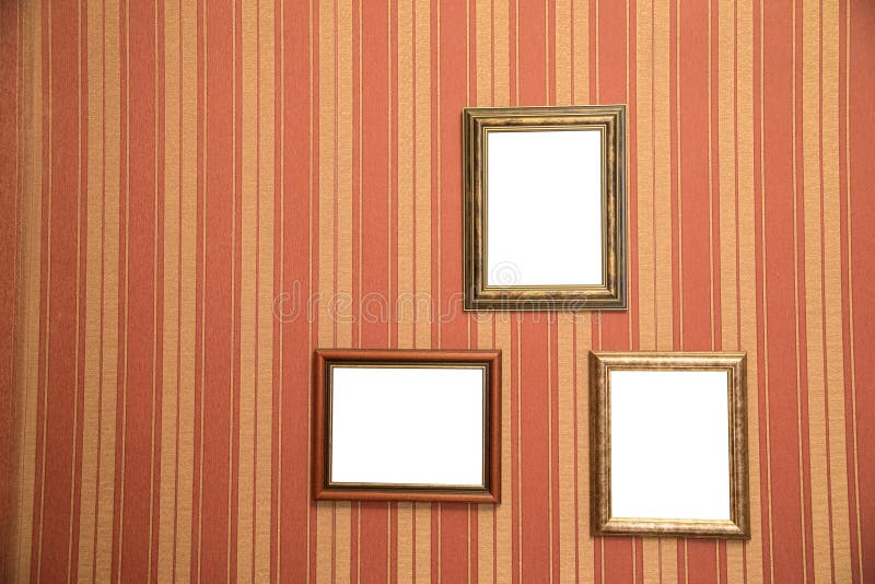 Several beautiful frames for photos of gold on a striped red wall stock photos