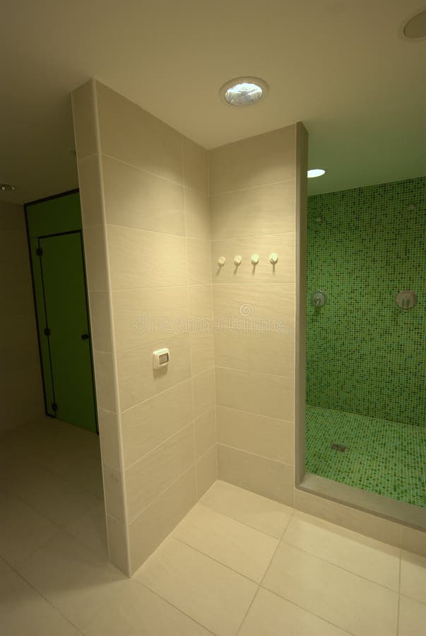 SPA showers bathroom. SPA Elegantly decorated public toilet in white and green mosaic - Row of showers and sinks in the sports club bathroom stock photography